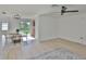 Open-concept living space with hardwood floors, dining table, and modern light fixture at 1110 Waterview E Blvd, Lakeland, FL 33801