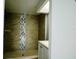 Bathroom showcasing a walk-in shower with decorative tile and a sink with vanity storage at 1206 Skyview Cv, Lakeland, FL 33801
