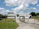Charming single-story home with light gray siding and a well-maintained lawn and rustic wooden fence at 1206 Skyview Cv, Lakeland, FL 33801