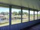 Enclosed porch with serene waterfront views and wood floors at 1206 Skyview Cv, Lakeland, FL 33801