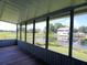 Enclosed porch with serene waterfront views and wood floors at 1206 Skyview Cv, Lakeland, FL 33801