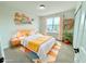 Cozy bedroom featuring a queen bed, colorful rug, and decorative shelves perfect for a room at 222 Carpenters Way # 71, Lakeland, FL 33805