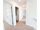 Bright hallway with neutral carpet leading to various rooms and closet spaces in the home at 222 Carpenters Way # 71, Lakeland, FL 33805