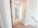 Well-lit hallway with carpet flooring and doorways leading to rooms, storage and stairs at 222 Carpenters Way # 71, Lakeland, FL 33805