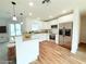 Modern white kitchen with stainless steel appliances and a breakfast bar overlooks the living area at 222 Carpenters Way # 71, Lakeland, FL 33805