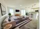 Bright, staged living room with modern furniture, large windows, and access to the backyard at 222 Carpenters Way # 71, Lakeland, FL 33805