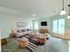 Bright living room is furnished with modern furniture, a TV, and a stylish rug at 222 Carpenters Way # 71, Lakeland, FL 33805