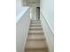 Carpeted staircase with white railing leading to the upper level of the home at 222 Carpenters Way # 71, Lakeland, FL 33805