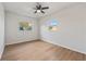 Inviting bedroom with wood flooring, ceiling fan, and two windows with bright sunlight at 2800 E Anderson St, Orlando, FL 32803