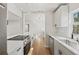 Kitchen with white cabinets, quartz countertops, stainless steel appliances, and hardwood floors at 2800 E Anderson St, Orlando, FL 32803