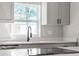 Kitchen sink with new faucet, quartz countertops, and stainless steel appliances in modern remodeled kitchen at 2800 E Anderson St, Orlando, FL 32803