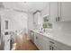 Modern kitchen with stainless steel appliances, white cabinets, and quartz countertops at 2800 E Anderson St, Orlando, FL 32803