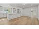 Open-concept living area with bar-top eating area, neutral paint, and wood flooring at 2800 E Anderson St, Orlando, FL 32803