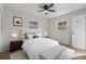 Staged bedroom features a white bed, neutral decor, and wood floors at 2800 E Anderson St, Orlando, FL 32803