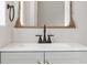 Close-up of the vanity with a dark faucet and ornate mirror at 2800 E Anderson St, Orlando, FL 32803