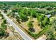 Aerial view of the property showcasing a large lot, mature trees, and neighborhood at 28712 Azalea Ave, Paisley, FL 32767