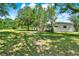 Home with a cozy back porch overlooking a large, tree-filled yard at 28712 Azalea Ave, Paisley, FL 32767