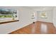 Sunlit bedroom featuring wood floors and large windows that let in natural light at 28712 Azalea Ave, Paisley, FL 32767