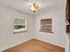 Bright dining room with wood floor, two windows, and overhead lighting at 28712 Azalea Ave, Paisley, FL 32767