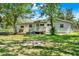 Inviting home featuring a charming porch with a well-maintained yard and mature trees at 28712 Azalea Ave, Paisley, FL 32767