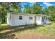 Charming single-story home featuring a cozy porch and well-maintained landscaping on a sunny day at 28712 Azalea Ave, Paisley, FL 32767