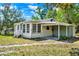 Charming home with carport, green lawn, and lush trees at 28712 Azalea Ave, Paisley, FL 32767