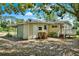 Backyard view of a cozy home with a covered carport and plenty of storage space at 28712 Azalea Ave, Paisley, FL 32767
