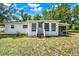 Quaint home with a covered carport and a well-maintained front yard at 28712 Azalea Ave, Paisley, FL 32767