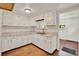Bright kitchen with white cabinetry, ample counter space, and durable wood flooring at 28712 Azalea Ave, Paisley, FL 32767