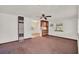 Open living room with ceiling fan, built-in shelving, and access to other rooms at 28712 Azalea Ave, Paisley, FL 32767
