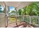 A covered porch with wood floors and railings creates a relaxing and inviting outdoor space at 28712 Azalea Ave, Paisley, FL 32767