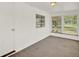Bright room featuring carpet flooring, neutral paint and window with views of the yard at 28712 Azalea Ave, Paisley, FL 32767