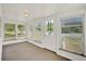 Sunroom features natural light, neutral carpet, and views of the surrounding greenery at 28712 Azalea Ave, Paisley, FL 32767
