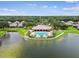 Aerial view of the community pool, clubhouse, and surrounding water features, showcasing the overall layout at 7991 Lake James Blvd, Lakeland, FL 33810