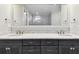 Bathroom featuring a double sink, granite countertop, modern faucet, and a bright recessed mirror at 7991 Lake James Blvd, Lakeland, FL 33810