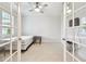 Bright bedroom with tile flooring, ceiling fan and glass doors at 7991 Lake James Blvd, Lakeland, FL 33810