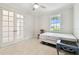 Comfortable bedroom with a chair and double doors at 7991 Lake James Blvd, Lakeland, FL 33810