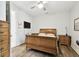 Comfortable bedroom featuring neutral decor, wood flooring, and ample space for furniture and relaxation at 7991 Lake James Blvd, Lakeland, FL 33810