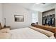 Cozy bedroom featuring a ceiling fan, neutral decor, and a view of a nicely sized closet at 7991 Lake James Blvd, Lakeland, FL 33810