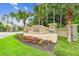 Inviting community entrance featuring the 'Lake James' sign surrounded by beautiful flowers and lush landscaping at 7991 Lake James Blvd, Lakeland, FL 33810