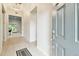 Bright entryway with tile flooring, a modern light fixture, and an open view to the living spaces at 7991 Lake James Blvd, Lakeland, FL 33810