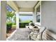 Inviting front porch with comfortable seating, lush landscaping, and a welcoming atmosphere at 7991 Lake James Blvd, Lakeland, FL 33810