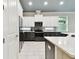 Contemporary kitchen featuring white and dark wood cabinets and updated appliances at 7991 Lake James Blvd, Lakeland, FL 33810