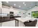 Modern kitchen with white cabinets, granite countertops, and stainless steel appliances at 7991 Lake James Blvd, Lakeland, FL 33810