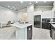 Spacious kitchen featuring an island, stainless steel appliances, and modern cabinetry at 7991 Lake James Blvd, Lakeland, FL 33810