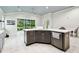 Bright kitchen with dark wood island, stainless steel appliances, and a view to living room at 7991 Lake James Blvd, Lakeland, FL 33810