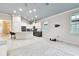 Bright, open-concept living area with recessed lighting and a seamless flow to the dining and kitchen areas at 7991 Lake James Blvd, Lakeland, FL 33810