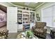 Relaxing lounge space with a built-in bookcase, a comfortable armchair, and a calming ambiance at 7991 Lake James Blvd, Lakeland, FL 33810