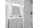 Stylish bathroom with modern vanity, contemporary mirror, and elegant marble-tiled shower at 9413 5Th Ave, Orlando, FL 32824