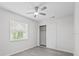 Light and airy bedroom with a ceiling fan, closet and a window overlooking a greenery view at 9413 5Th Ave, Orlando, FL 32824
